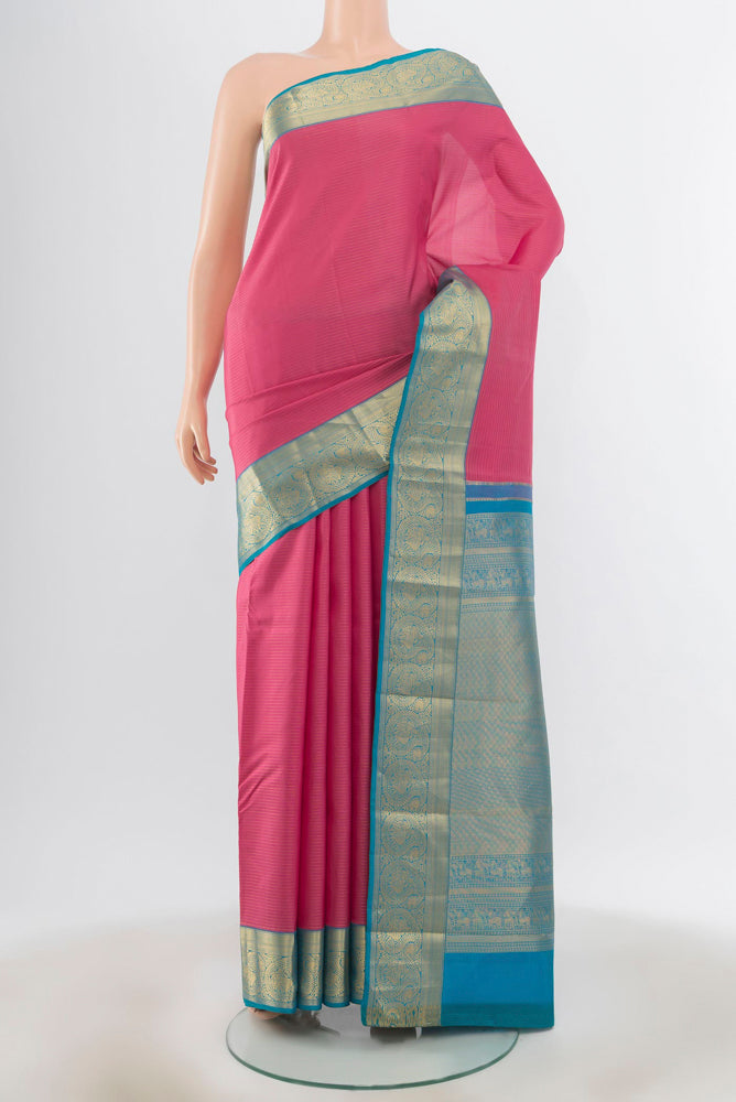 Rose Gold Kanchipuram Silk Saree with Zari Butta on the body and Silk Border.  displayed on a mannequin