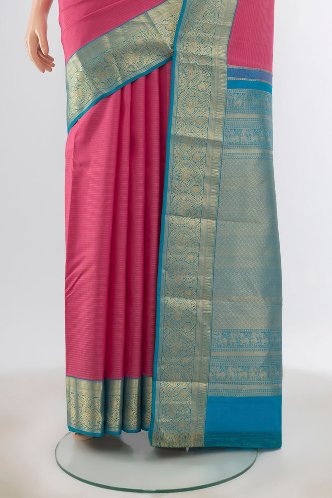 Pleats and pallu of Rose Gold Kanchipuram Silk Saree with Zari Butta on the body and Silk Border. 