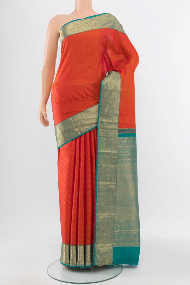 Pure Silk Pure Zari Peach Kanchipuram Saree with Zari Butta on the body and Silk Border.  displayed on a mannequin