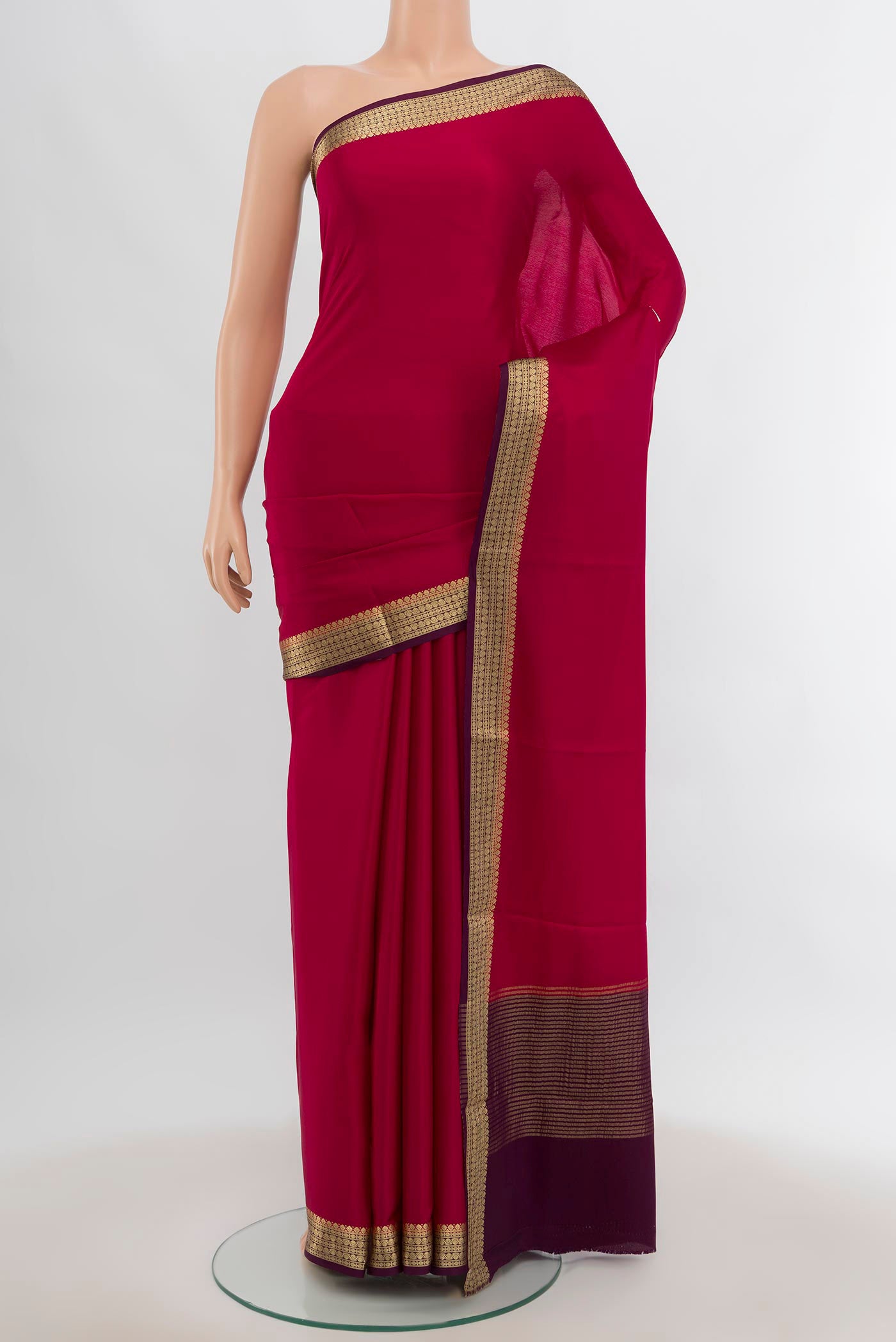 Dark Pink Mysore Crepe Saree with Zari Butta on the body and Silk Border.  displayed on a mannequin