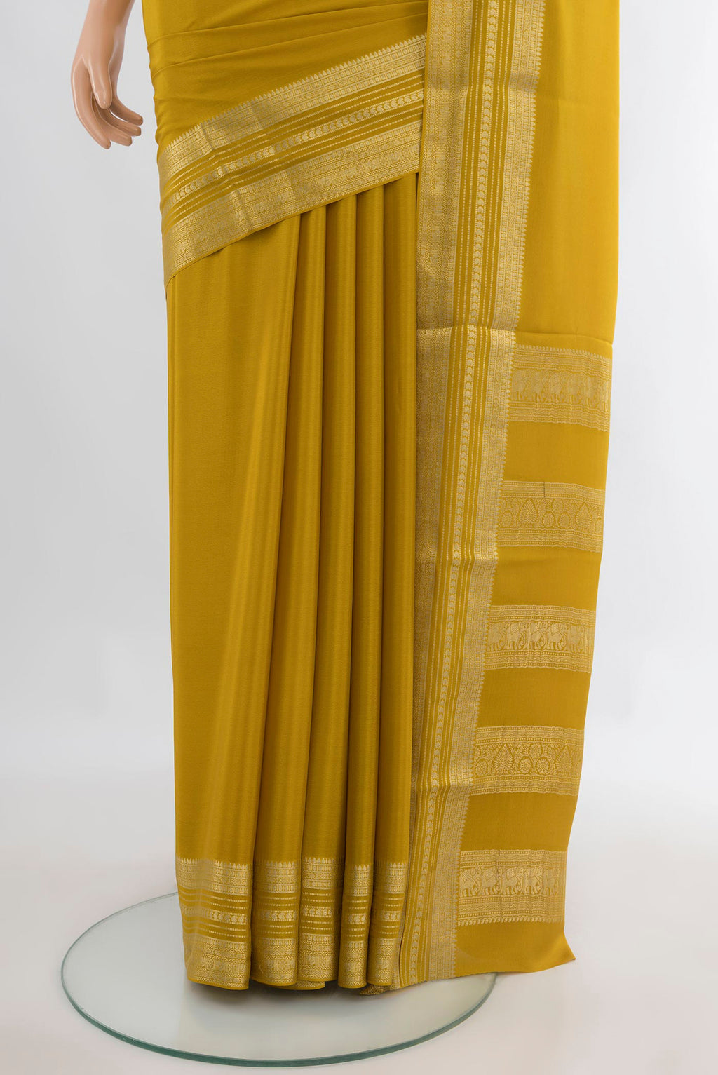 Pleats and pallu of Mustard Mysore Crepe Saree with Plain Body and Zari Border. 