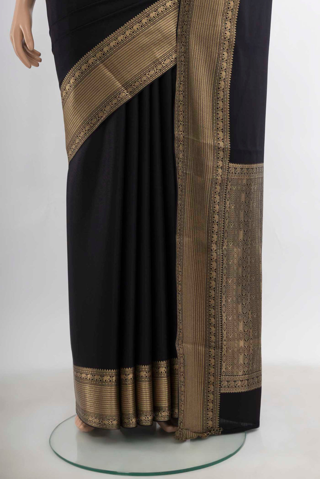 Pleats and pallu of Black Mysore Crepe Saree with Zari Butta on the body and Silk Border. 