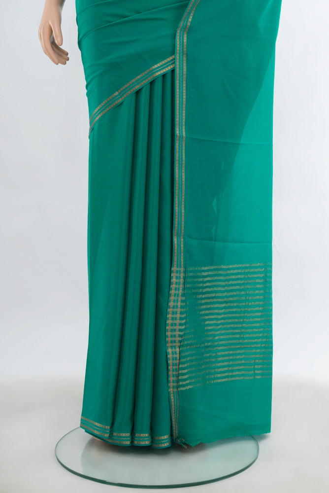 Pleats and pallu of Peacock Blue Mysore Crepe Saree with Plain Body and Silk Border. 