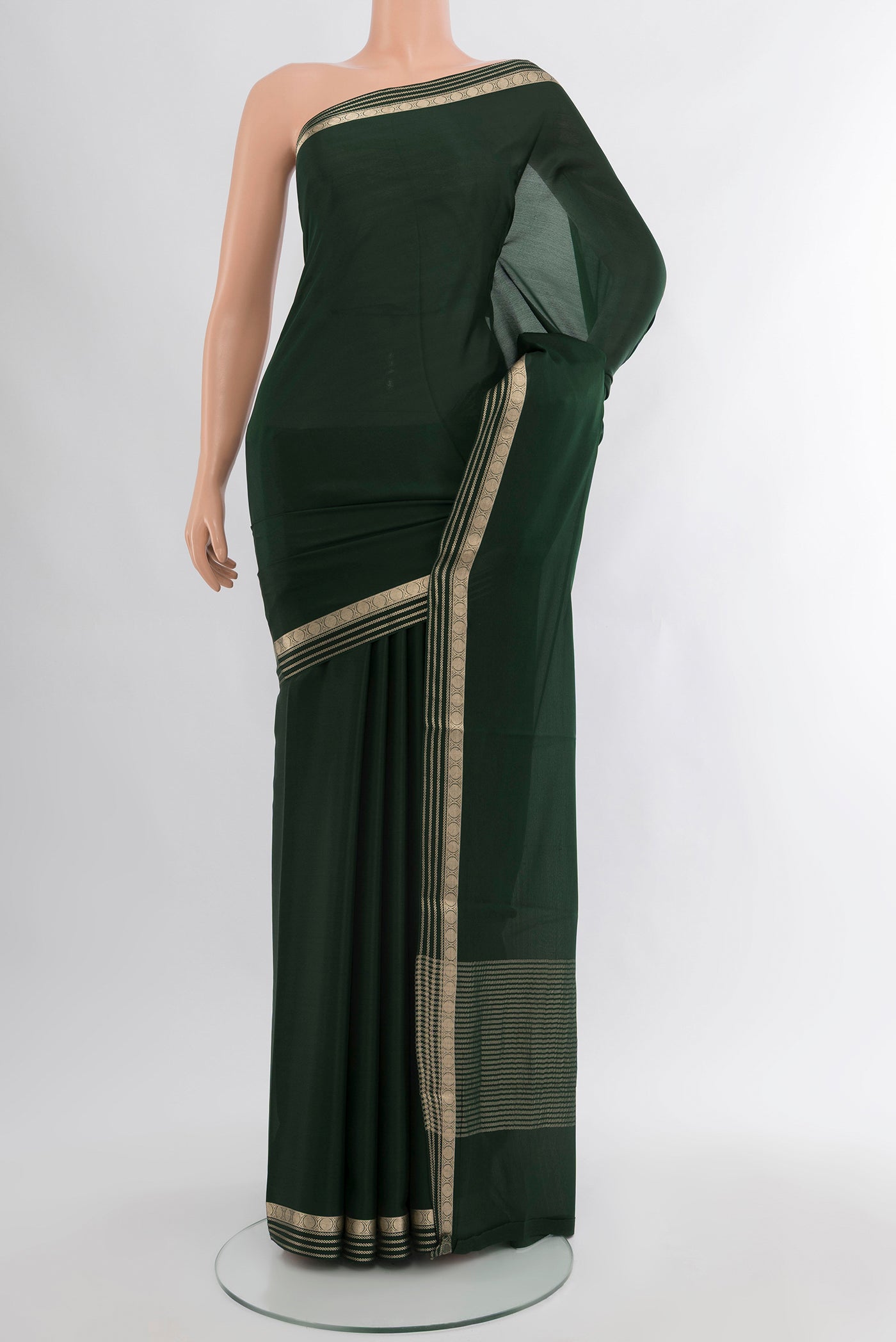 Bottle Green Mysore Crepe Saree with Plain Body and Zari Border.  displayed on a mannequin