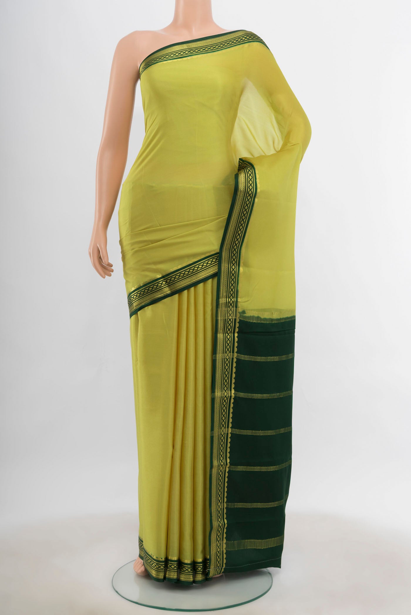 Light Green Mysore Crepe Saree with Zari Butta on the body and Silk Border.  displayed on a mannequin