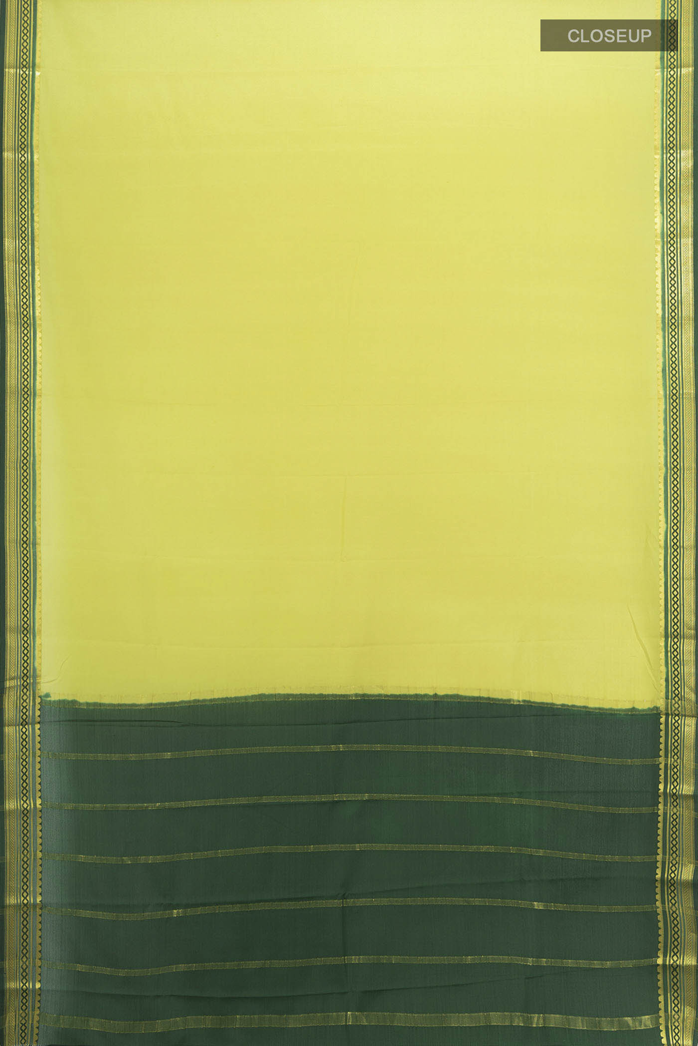 Flat view of Light Green Mysore Crepe Saree with Zari Butta on the body and Silk Border. 