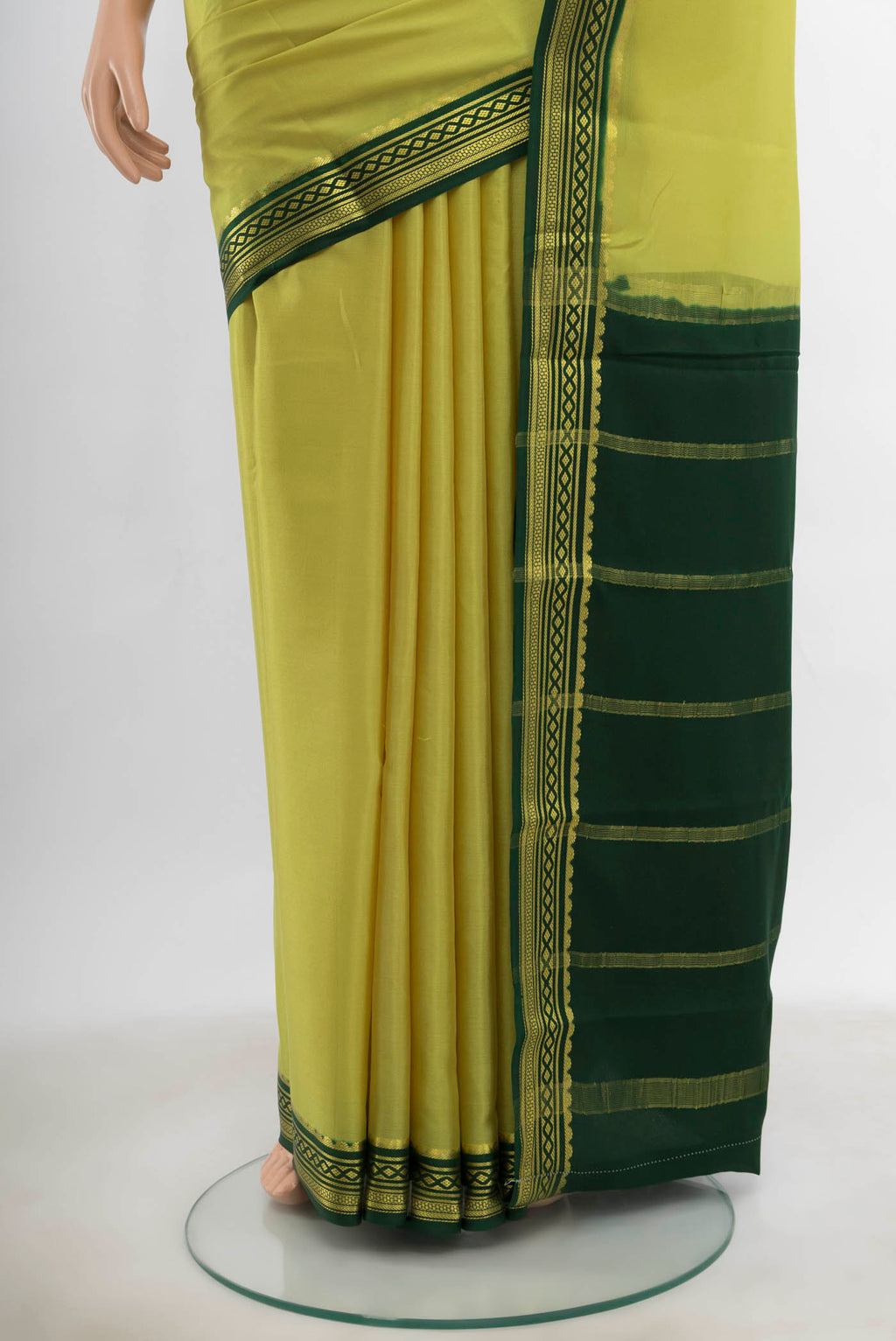 Pleats and pallu of Light Green Mysore Crepe Saree with Zari Butta on the body and Silk Border. 