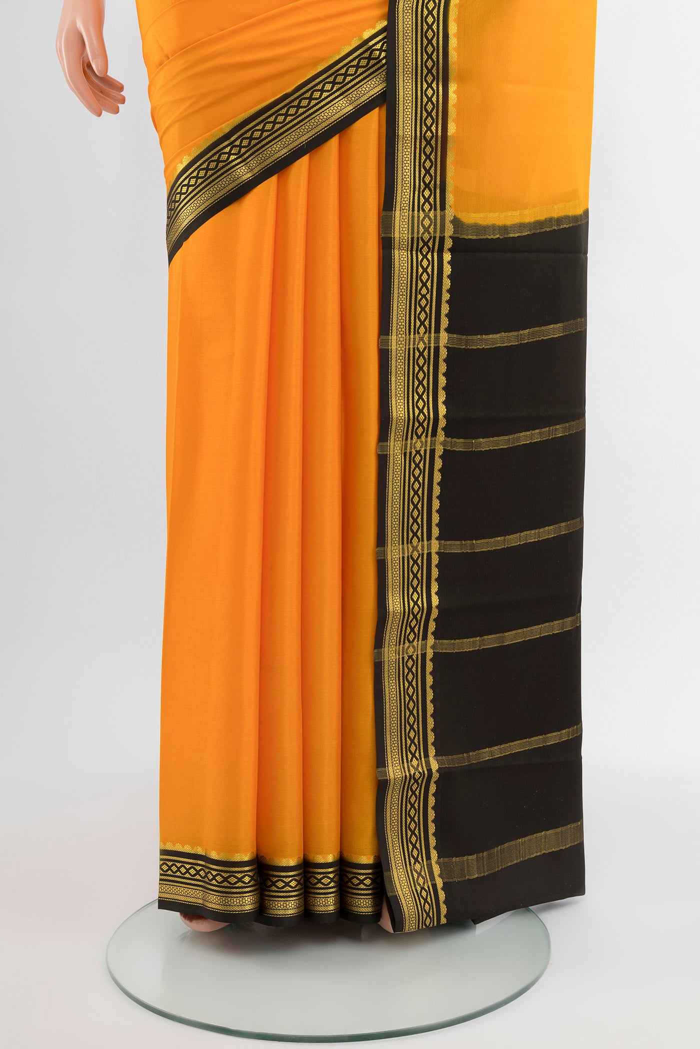 Pleats and pallu of Yellow Mysore Crepe Saree with Plain Body and Silk Border. 