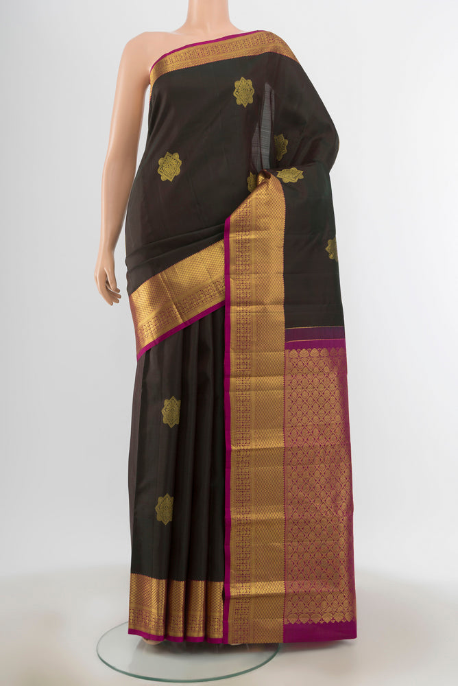 Black Kanchipuram Silk Saree with Zari Butta on the body and Silk Border.  displayed on a mannequin