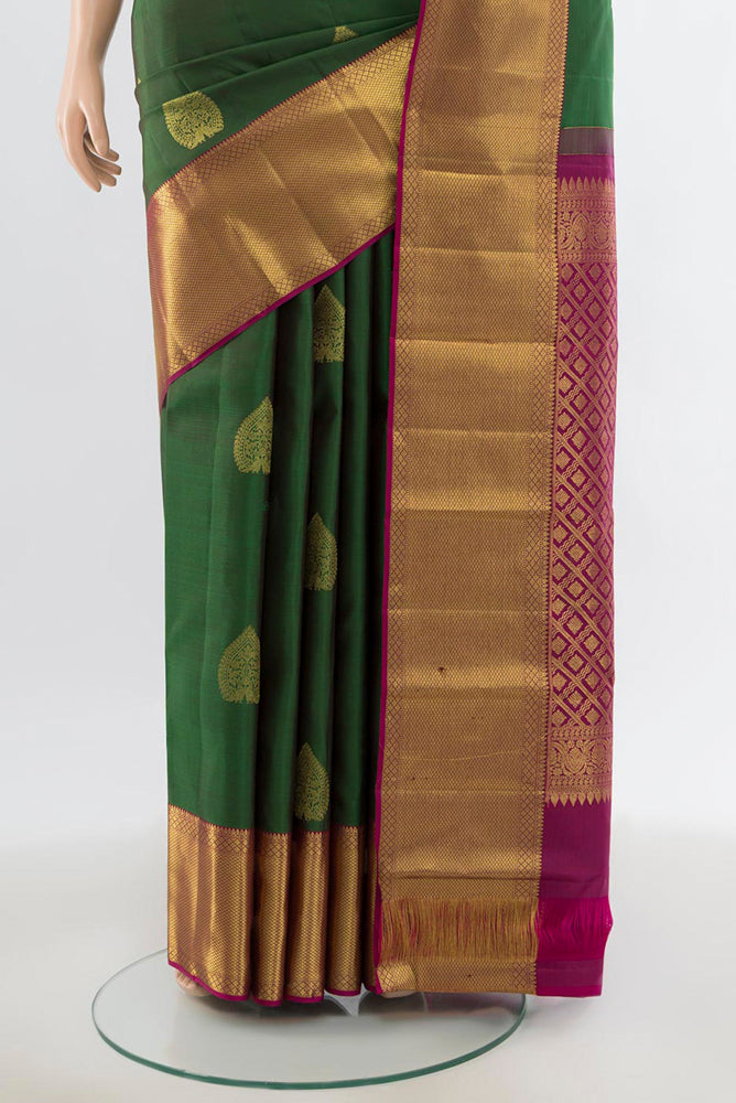 Pleats and pallu of Bottle Green Kanchipuram Silk Saree with Zari Butta on the body and Silk Border. 