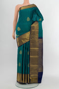 Peacock Blue Kanchipuram Silk Saree with Zari Butta on the body and Silk Border.  displayed on a mannequin