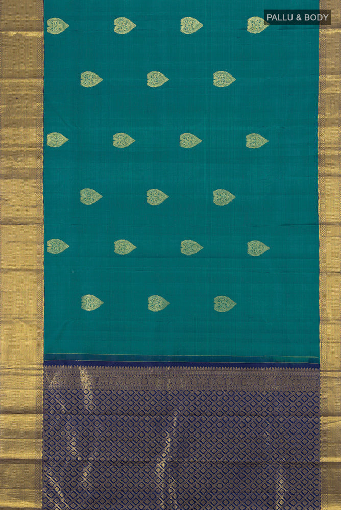 Flat view of Peacock Blue Kanchipuram Silk Saree with Zari Butta on the body and Silk Border. 