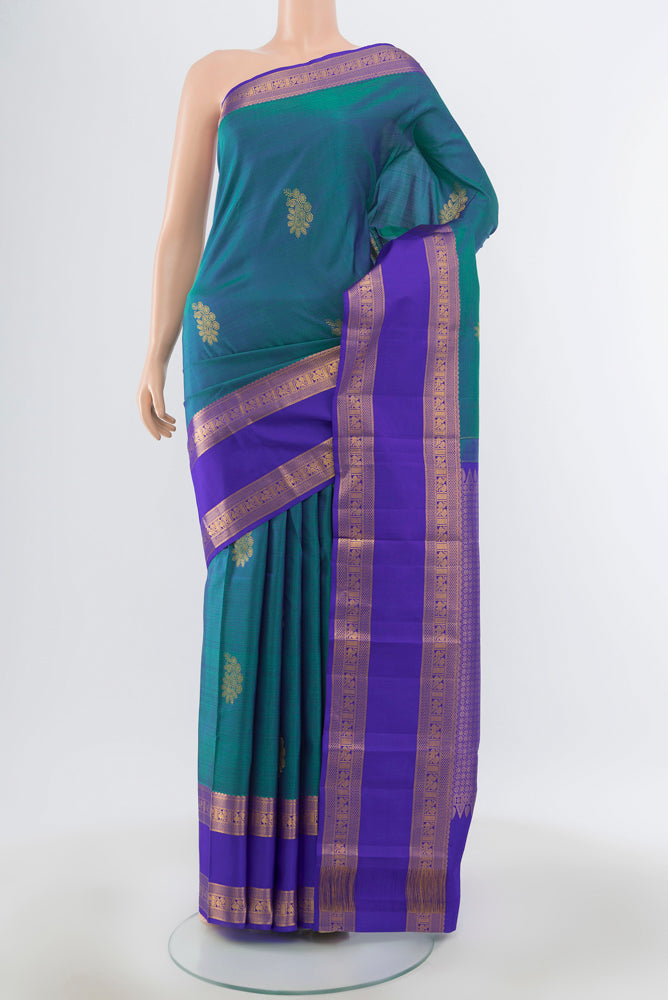 Peacock Blue Kanchipuram Silk Saree with Plain Body and Silk Border.  displayed on a mannequin