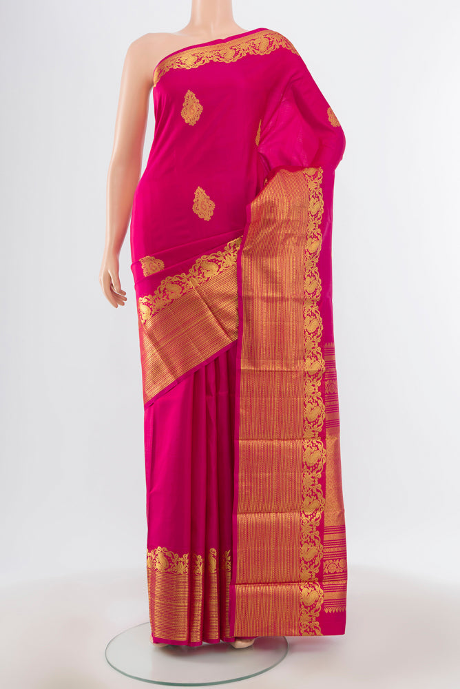 Pure Silk Pure Zari Magenta Kanchipuram Saree with Zari Butta on the body and Silk Border.  displayed on a mannequin