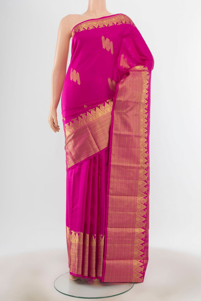 Magenta Kanchipuram Silk Saree with Zari Butta on the body and Silk Border.  displayed on a mannequin