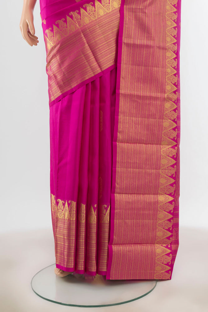 Pleats and pallu of Magenta Kanchipuram Silk Saree with Zari Butta on the body and Silk Border. 