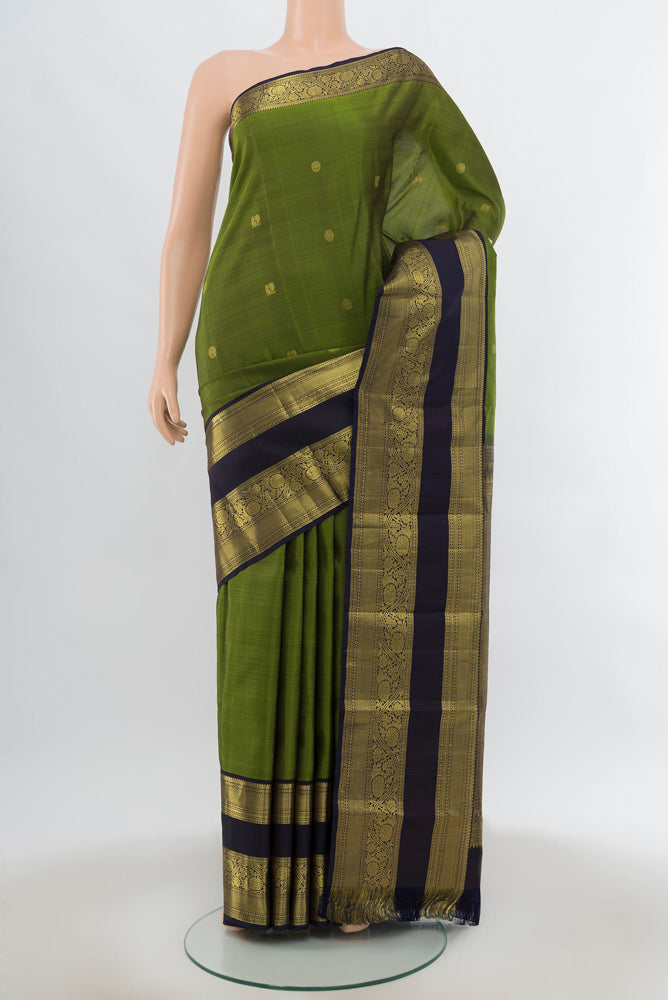 Light Green Kanchipuram Silk Saree with Zari Butta on the body and Silk Border.  displayed on a mannequin