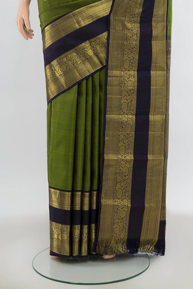 Pleats and pallu of Light Green Kanchipuram Silk Saree with Zari Butta on the body and Silk Border. 