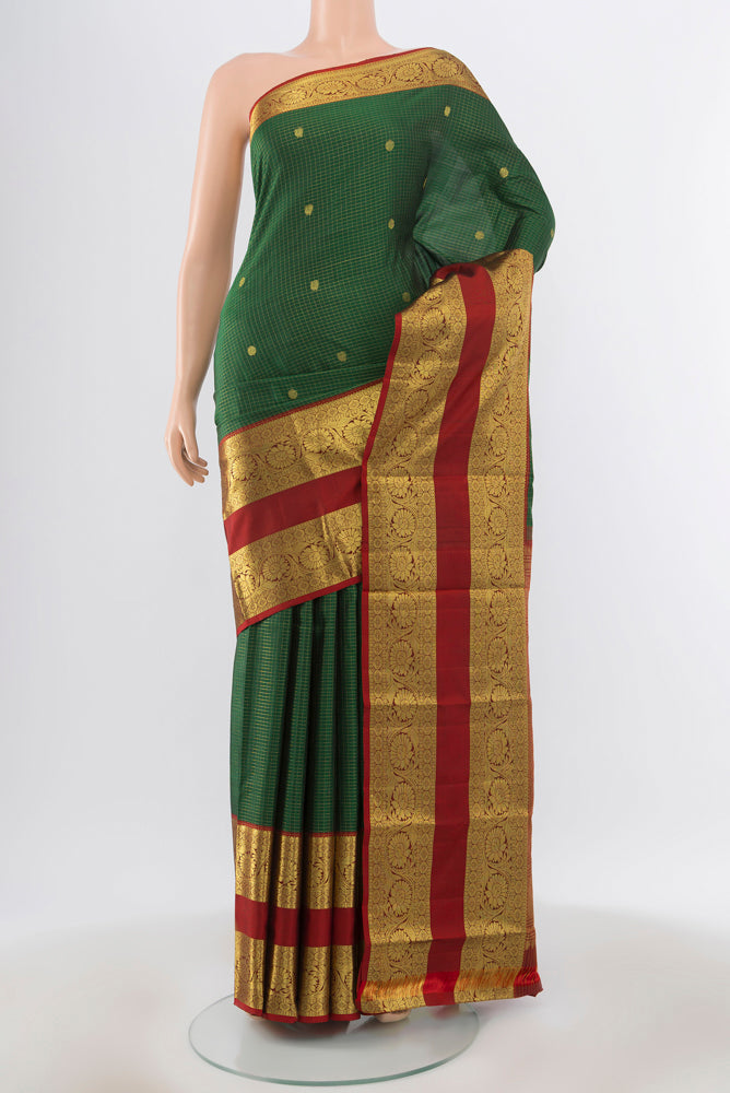 Pure Silk Pure Zari Bottle Green Kanchipuram Saree with Zari Butta on the body and Silk Border.  displayed on a mannequin