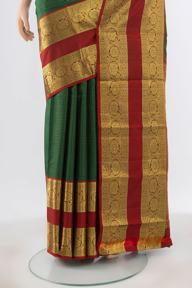 Pleats and pallu of Pure Silk Pure Zari Bottle Green Kanchipuram Saree with Zari Butta on the body and Silk Border. 