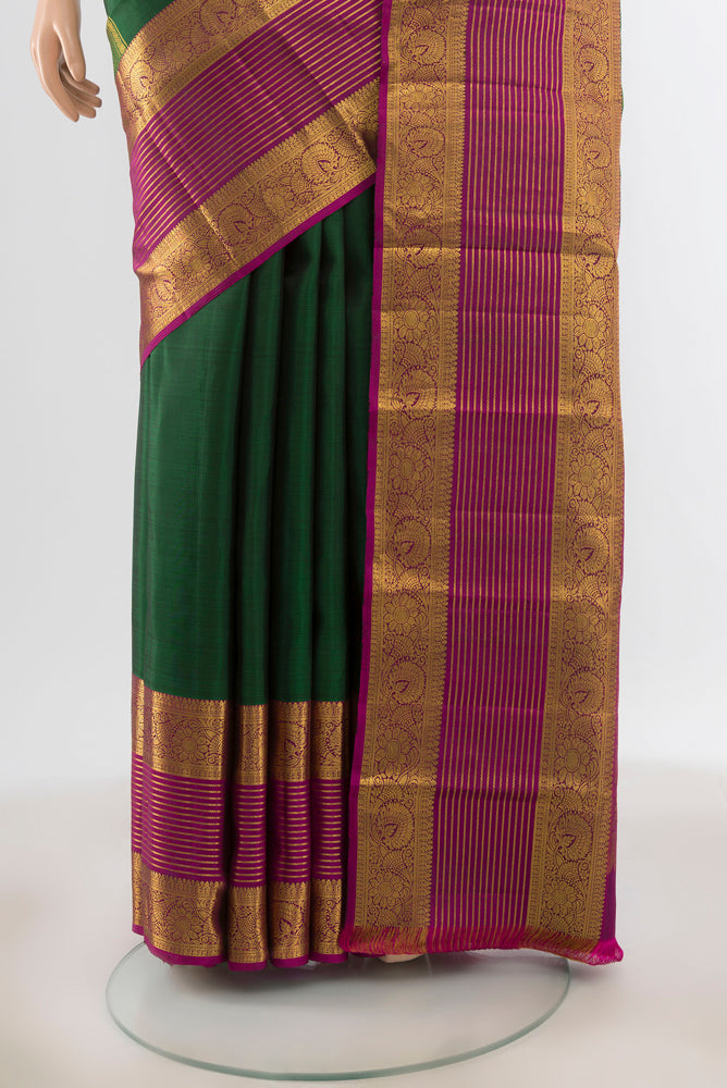 Pleats and pallu of Pure Silk Pure Zari Bottle Green Kanchipuram Saree with Zari Butta on the body and Silk Border. 