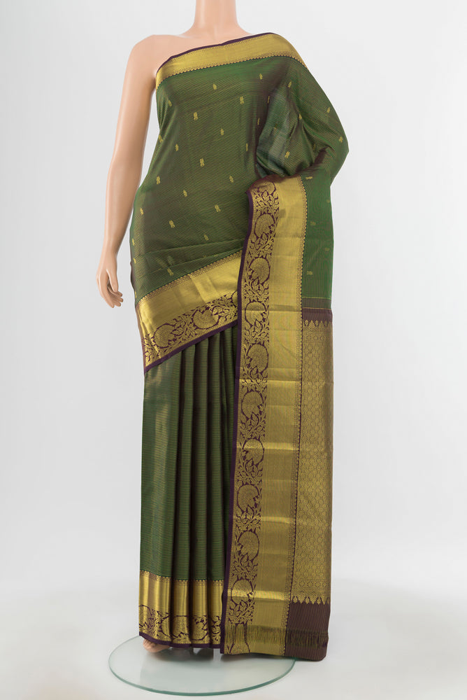Pure Silk Pure Zari Green Kanchipuram Saree with Zari Butta on the body and Silk Border.  displayed on a mannequin