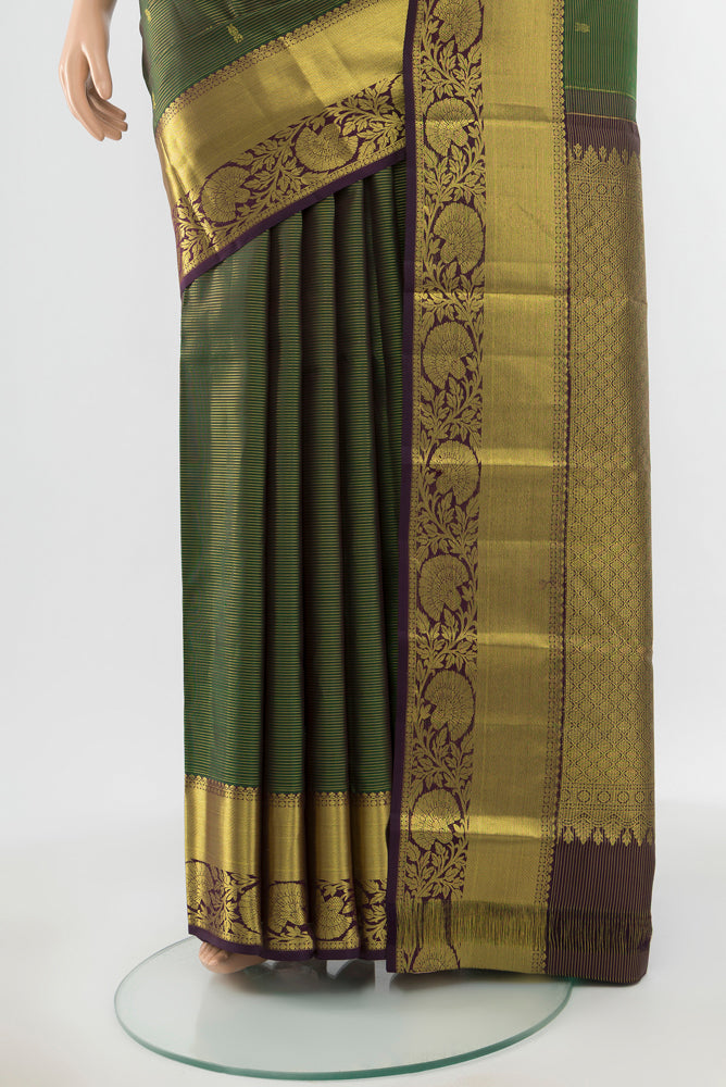 Pleats and pallu of Pure Silk Pure Zari Green Kanchipuram Saree with Zari Butta on the body and Silk Border. 