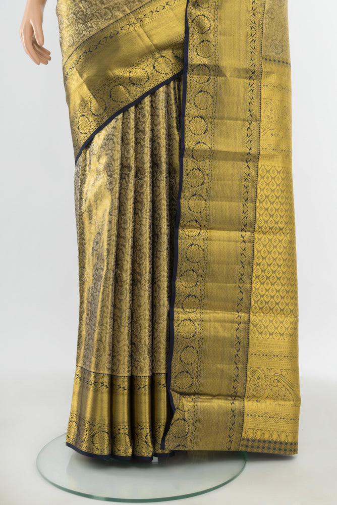 Pleats and pallu of Pure Silk Pure Zari Golden Kanchipuram Saree with Zari Butta on the body and Silk Border. 