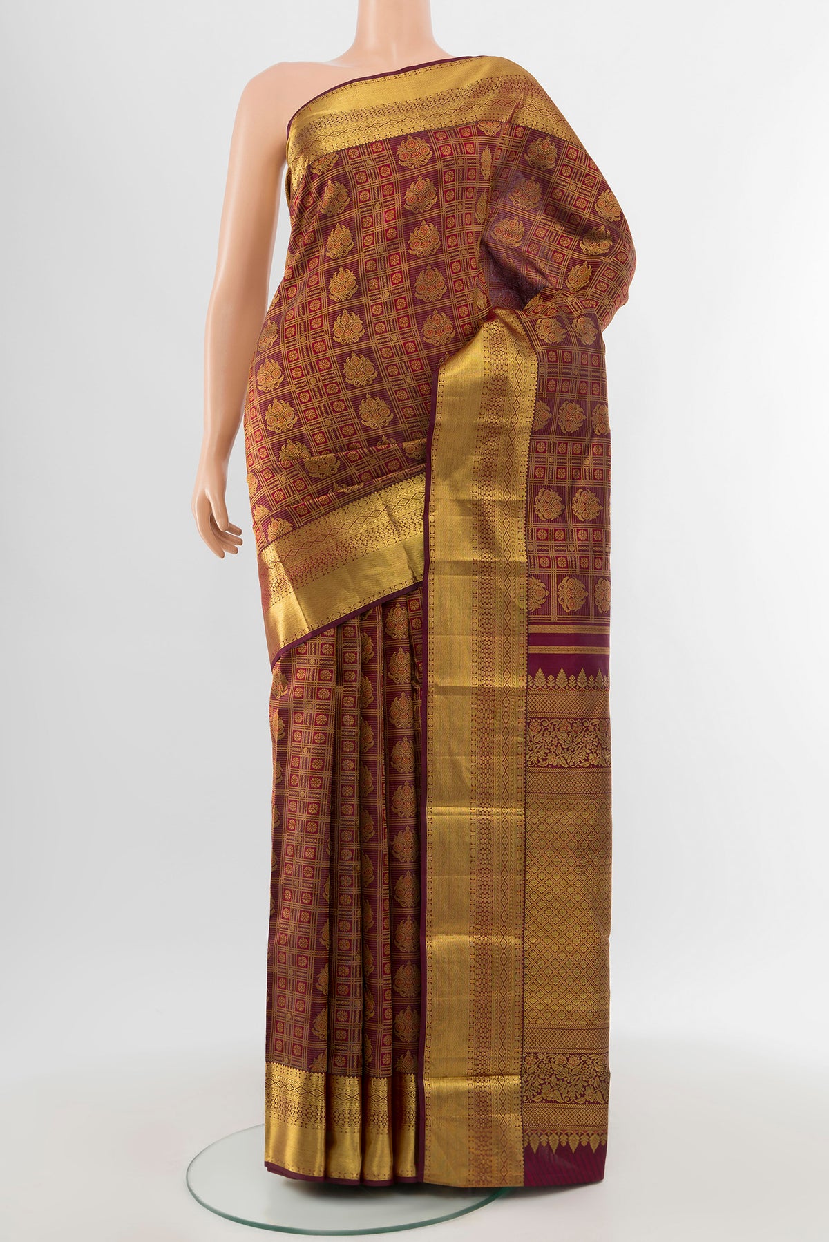 Pure Silk Pure Zari Maroon Kanjivaram Saree with Zari Butta on the body and Silk Border.  displayed on a mannequin