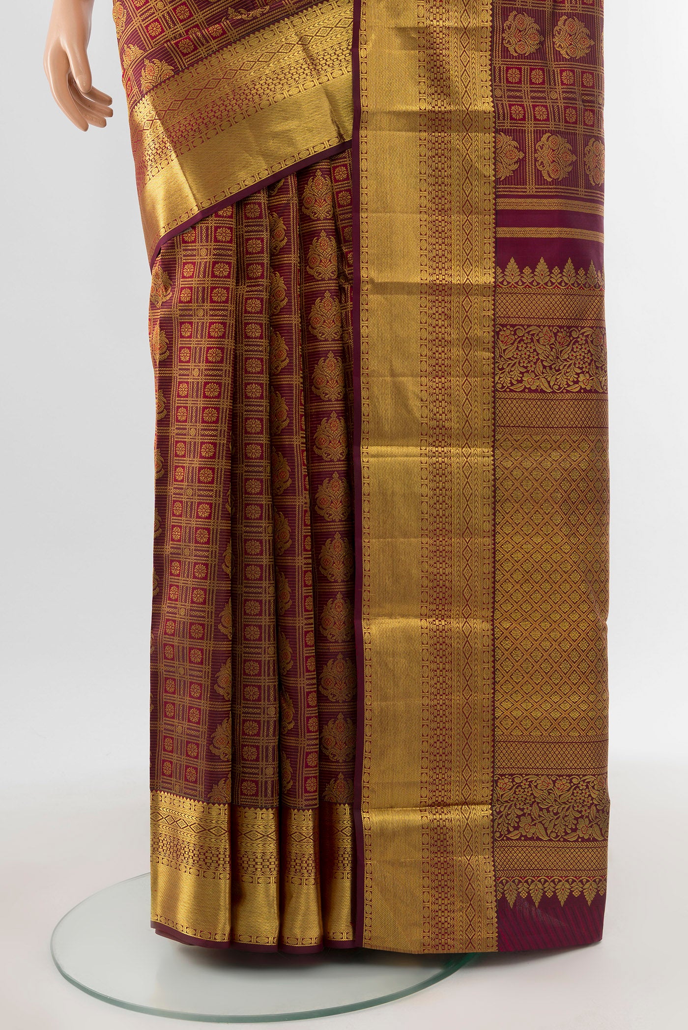 Pleats and pallu of Pure Silk Pure Zari Maroon Kanjivaram Saree with Zari Butta on the body and Silk Border. 