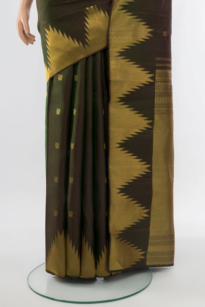Pleats and pallu of Mehandi Green Kanchipuram Silk Saree with Zari Butta on the body and Silk Border. 