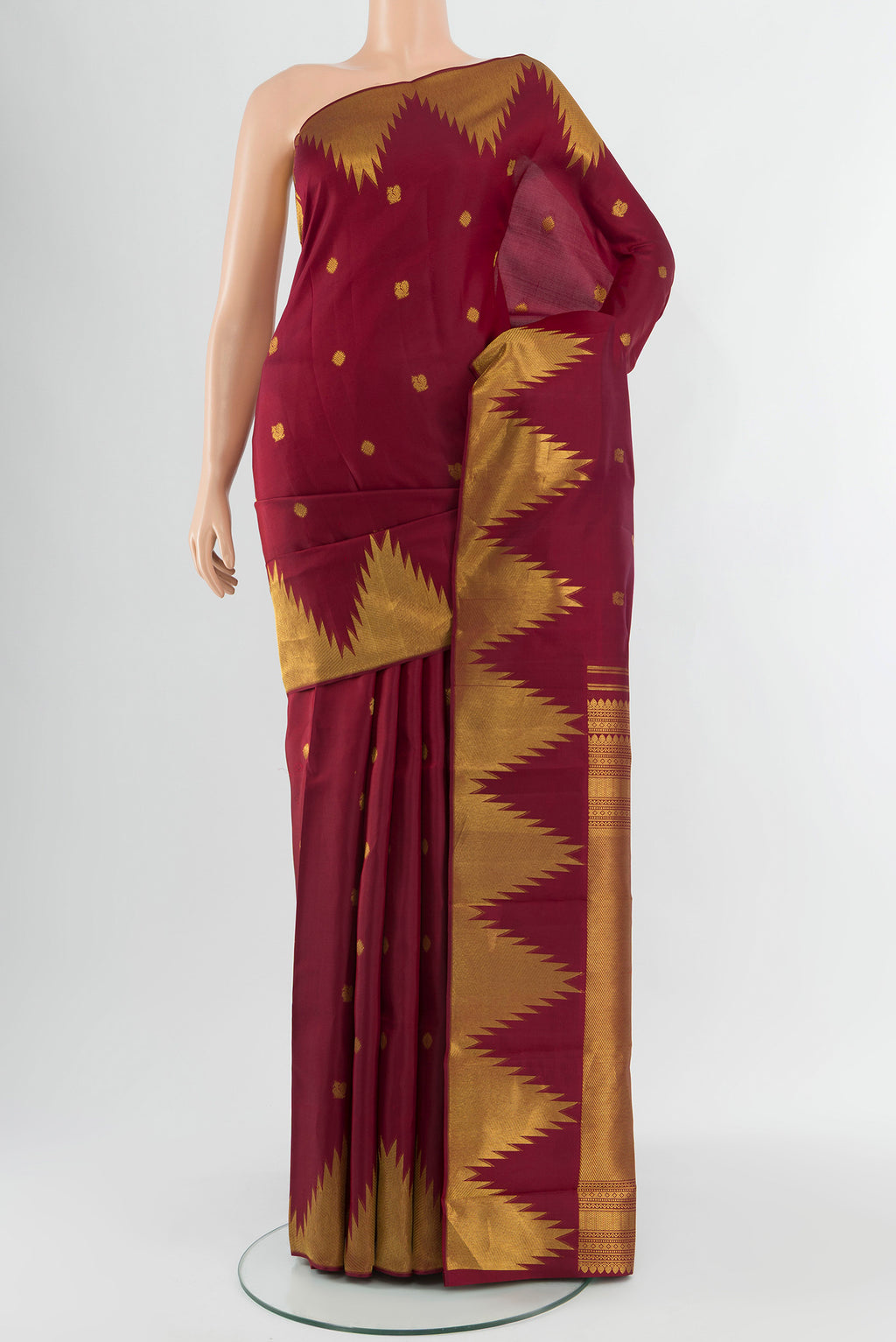 Maroon Kanchipuram Silk Saree with Zari Butta on the body and Temple Border.  displayed on a mannequin
