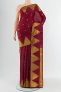 Maroon Kanchipuram Silk Saree with Zari Butta on the body and Temple Border.  displayed on a mannequin