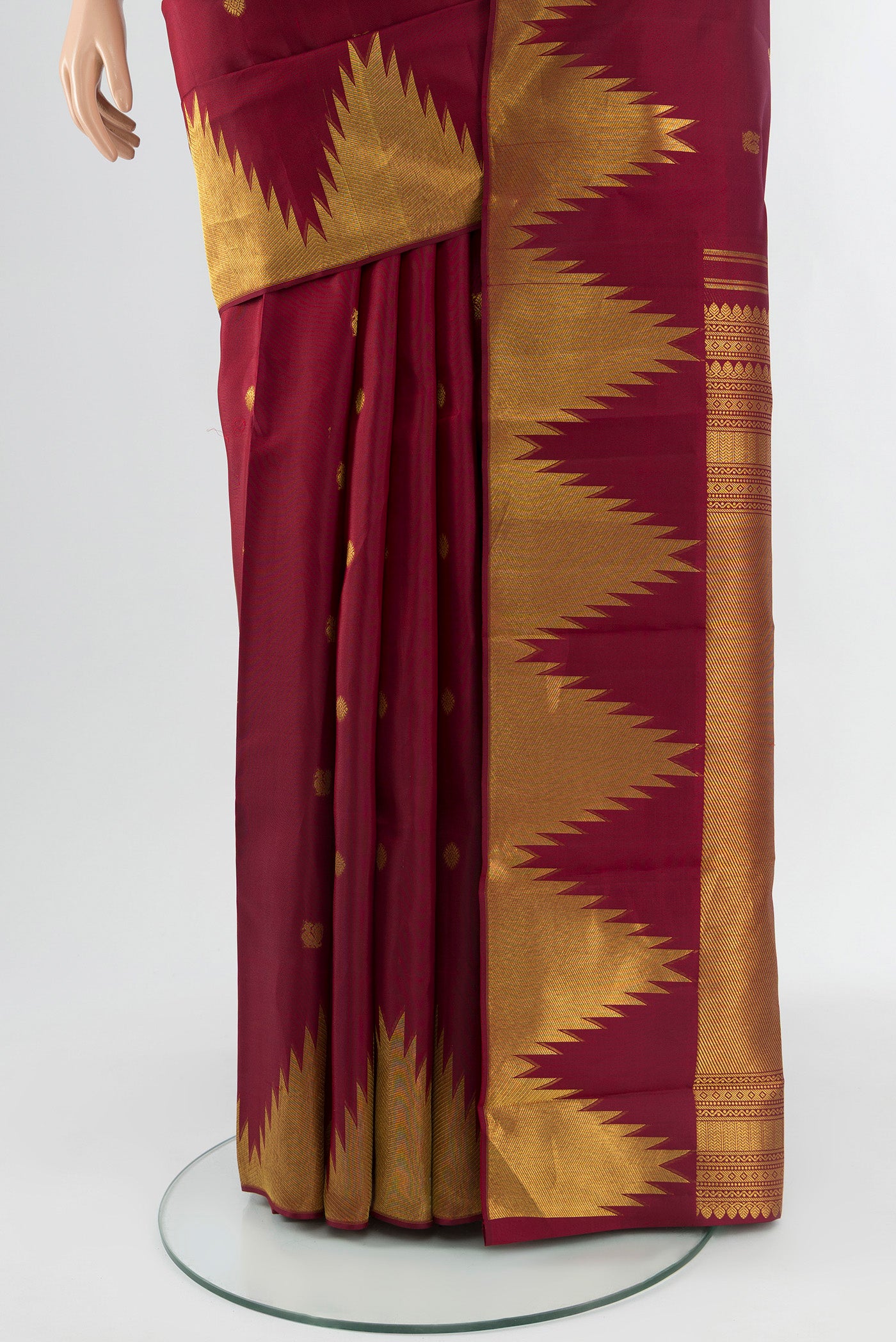 Pleats and pallu of Maroon Kanchipuram Silk Saree with Zari Butta on the body and Temple Border. 
