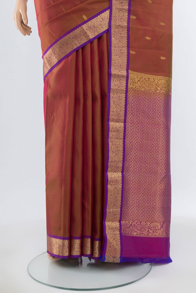 Pleats and pallu of Pure Silk Pure Zari Maroon Kanjivaram Saree with Zari Butta on the body and Silk Border. 