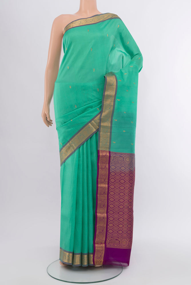 Sky Blue Kanjivaram Silk Saree with Zari Butta on the body and Silk Border.  displayed on a mannequin
