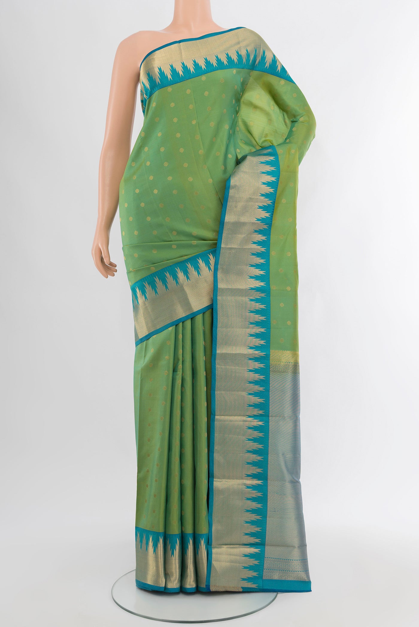 Light Green Kanchipuram Silk Saree with Zari Butta on the body and Zari Border.  displayed on a mannequin