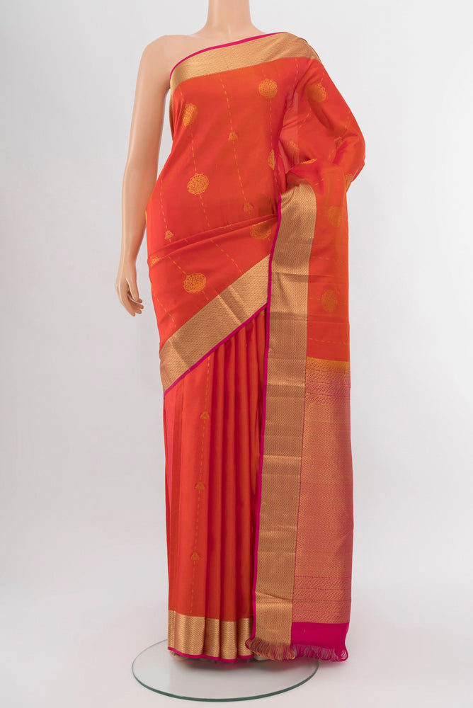 Peach Kanchipuram Silk Saree with Zari Brocade on the body and Silk Border.  displayed on a mannequin