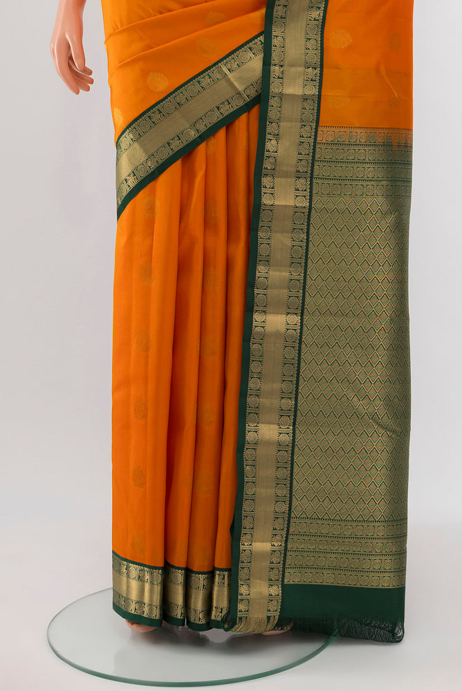 Pleats and pallu of Yellow Kanchipuram Silk Saree with Zari Butta on the body and Silk Border. 
