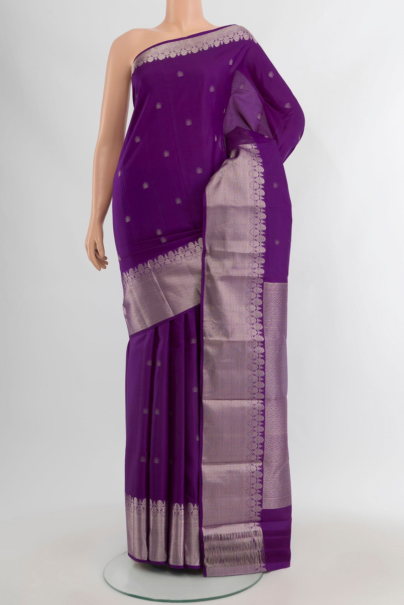 Violet Kanchipuram Silk Saree with Zari Butta on the body and Zari Border.  displayed on a mannequin