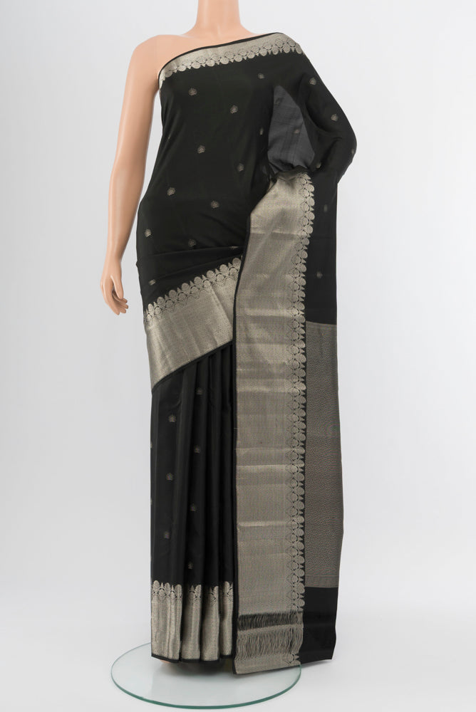 Black Kanchipuram Silk Saree with Zari Butta on the body and Silk Border.  displayed on a mannequin
