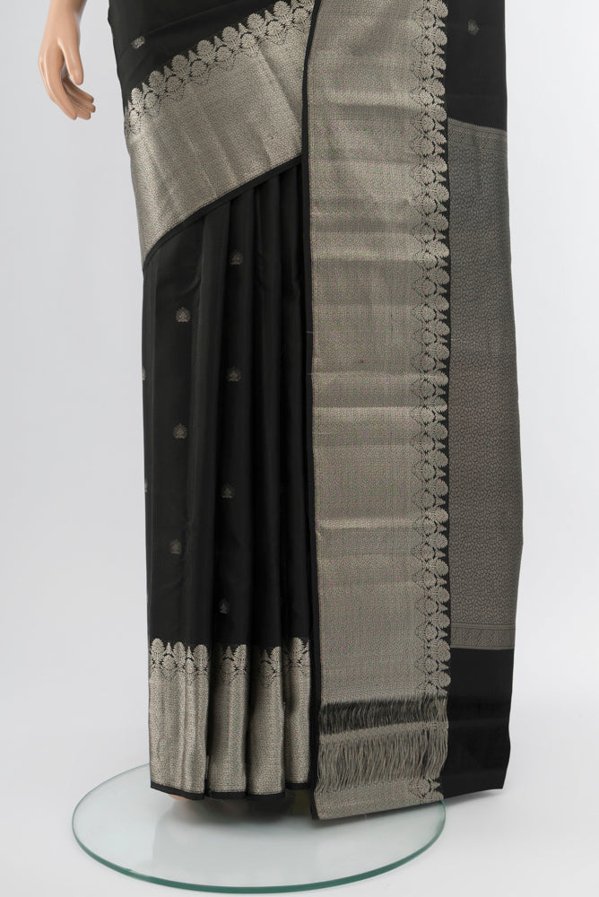 Pleats and pallu of Black Kanchipuram Silk Saree with Zari Butta on the body and Silk Border. 