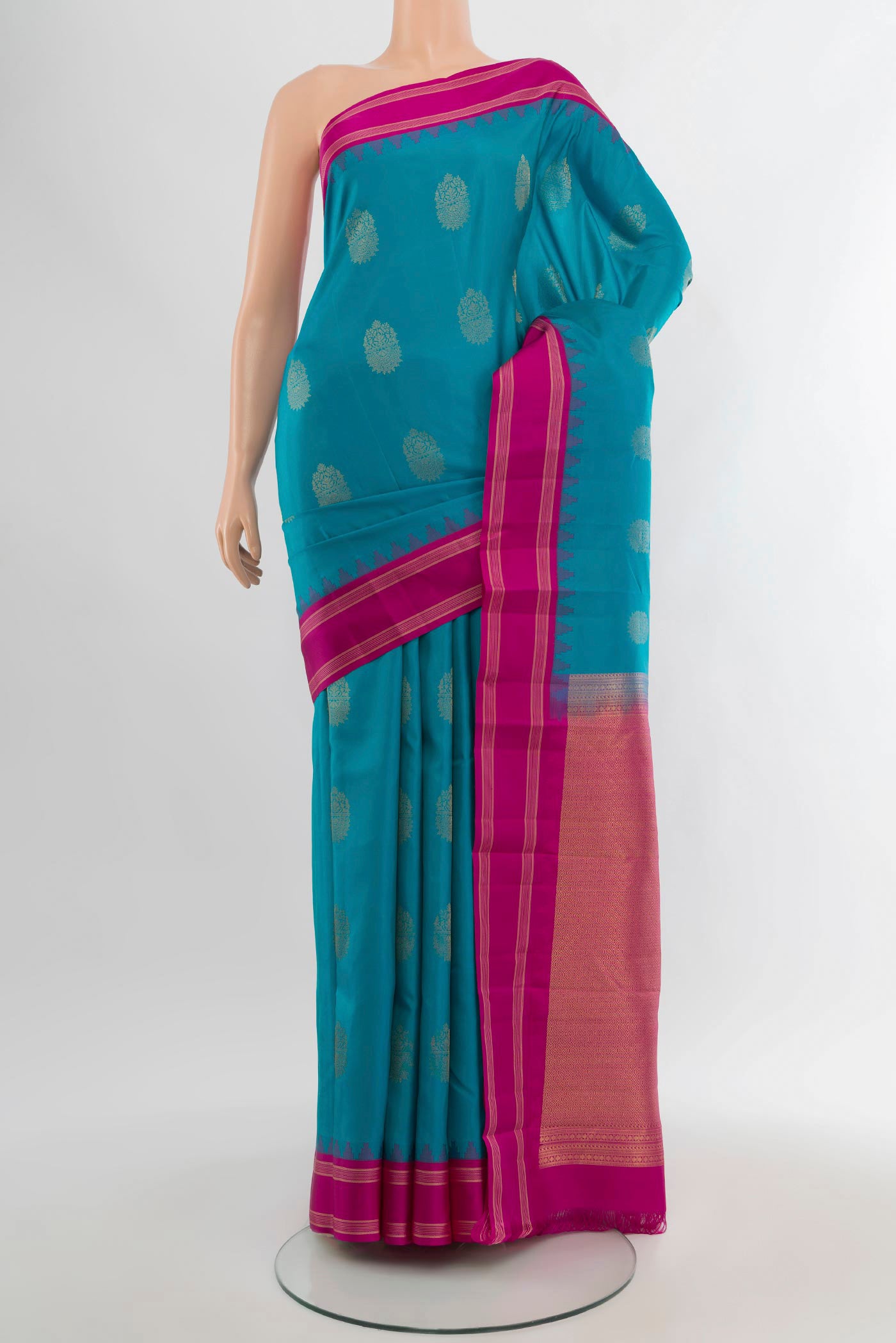 Blue Kanchipuram Silk Saree with Zari Butta on the body and Zari Border.  displayed on a mannequin