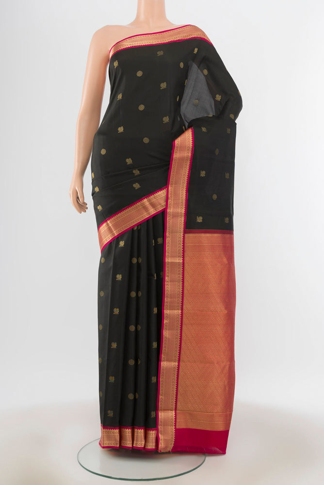 Black Kanchipuram Silk Saree with Zari Butta on the body and Silk Border.  displayed on a mannequin
