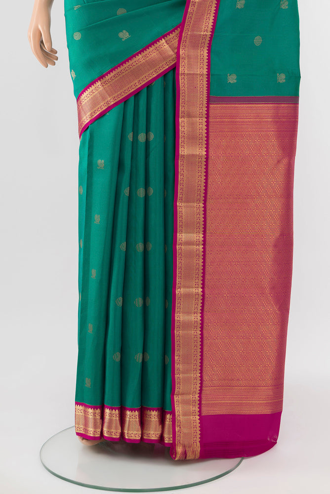 Pleats and pallu of Peacock Blue Kanchipuram Silk Saree with Zari Butta on the body and Silk Border. 