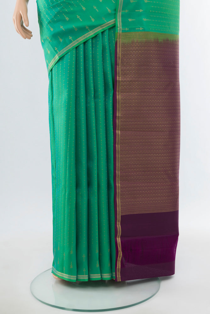 Pleats and pallu of Light Green Kanchipuram Silk Saree with Zari Butta on the body and Silk Border. 