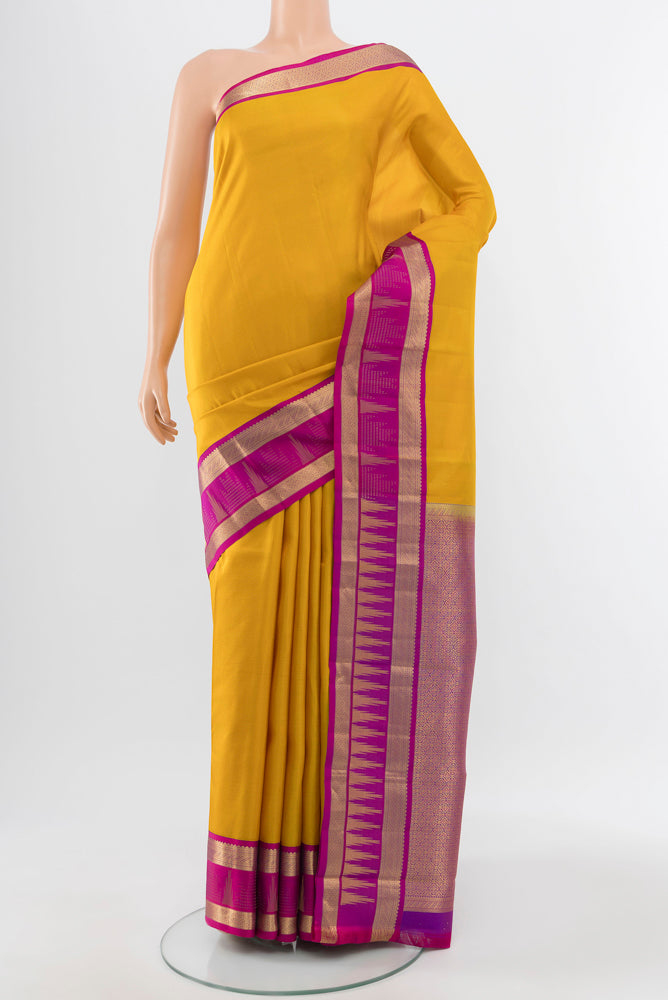 Pure Silk Pure Zari Yellow Kanjivaram Saree with Zari Butta on the body and Silk Border.  displayed on a mannequin