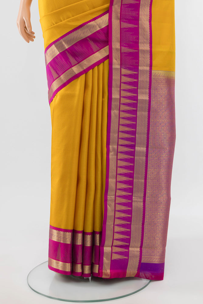 Pleats and pallu of Pure Silk Pure Zari Yellow Kanjivaram Saree with Zari Butta on the body and Silk Border. 