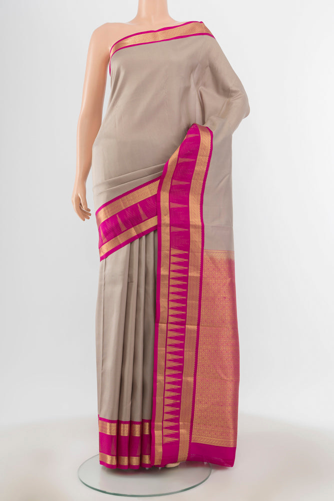 Teal Kanjivaram Silk Saree with Zari Butta on the body and Silk Border.  displayed on a mannequin
