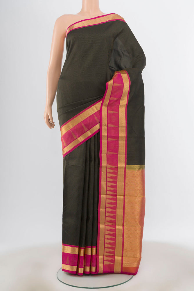Black Kanjivaram Silk Saree with Zari Butta on the body and Silk Border.  displayed on a mannequin